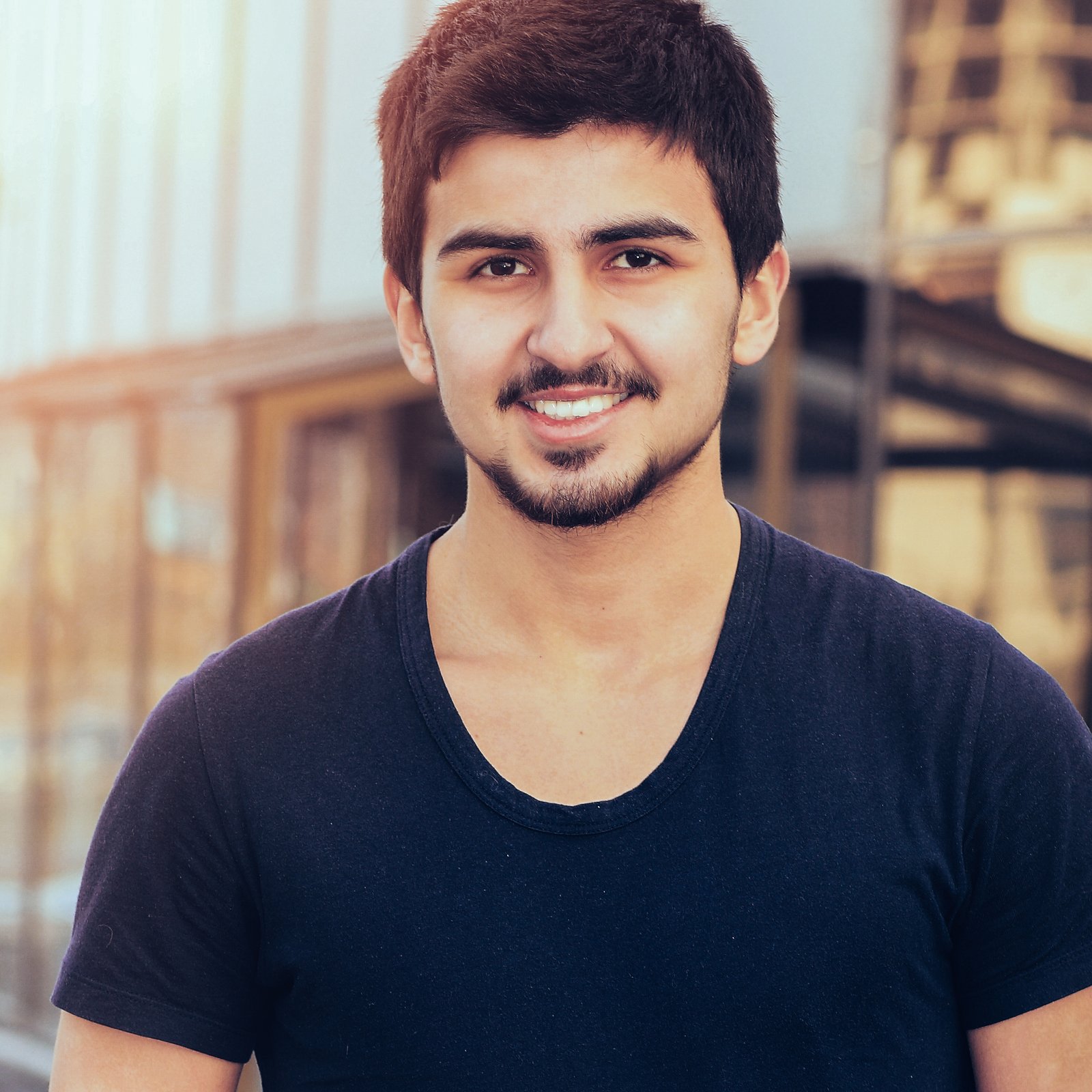Happy Manager in a vest on a background of an office building on a sunny day